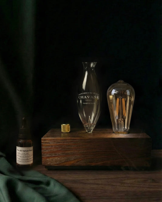 Vintage-style light bulb and bottle on a wooden base with smoke effect
