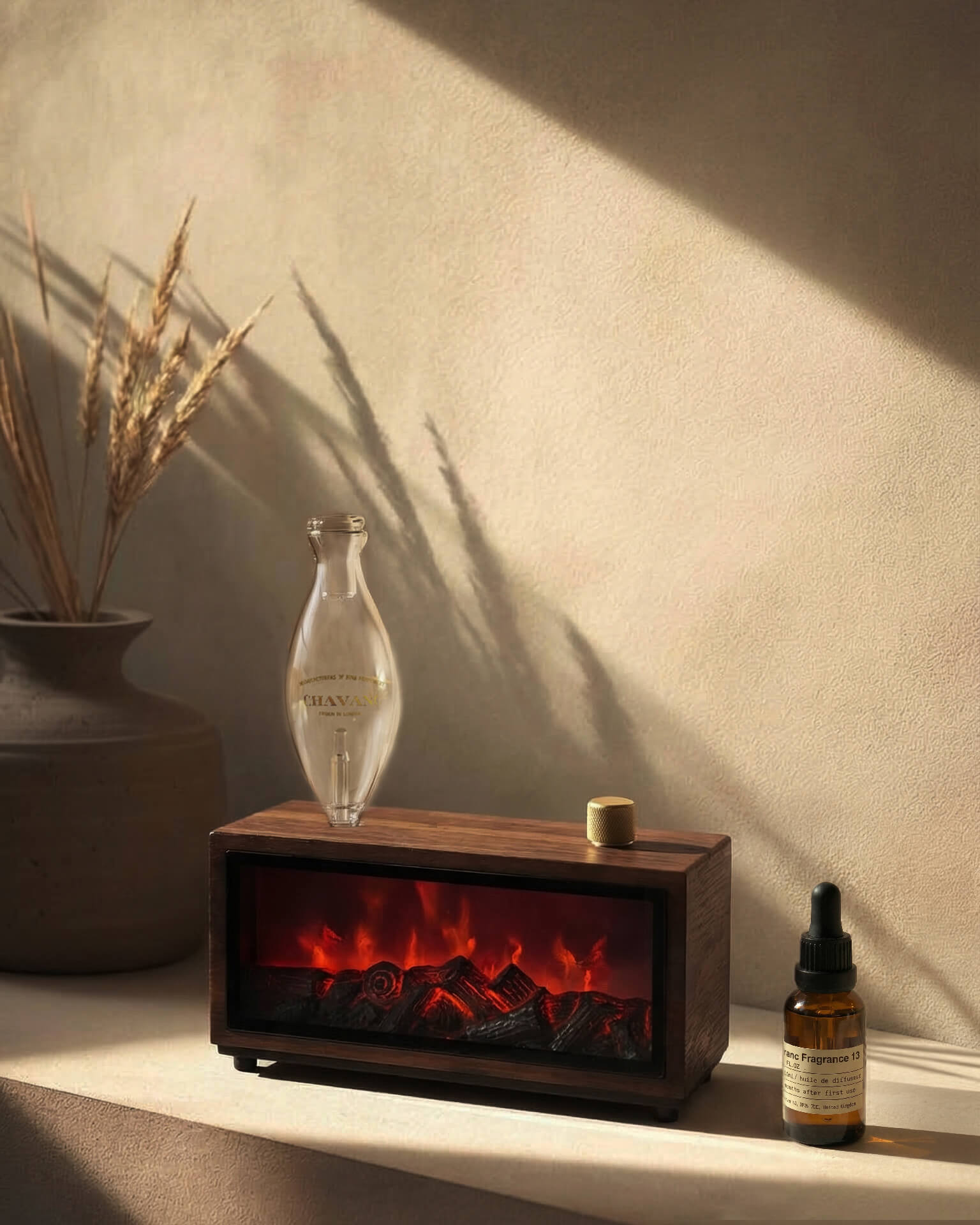 Chavanc-Aroma_Wooden fireplace-style waterless diffuser with glowing embers on a shelf, accompanied by decorative items.