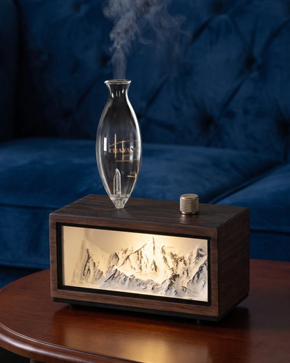 Chavanc Alpine waterless essential oil diffuser with illuminated snow mountain relief landscape in dark walnut wood base and hand-blown glass chamber