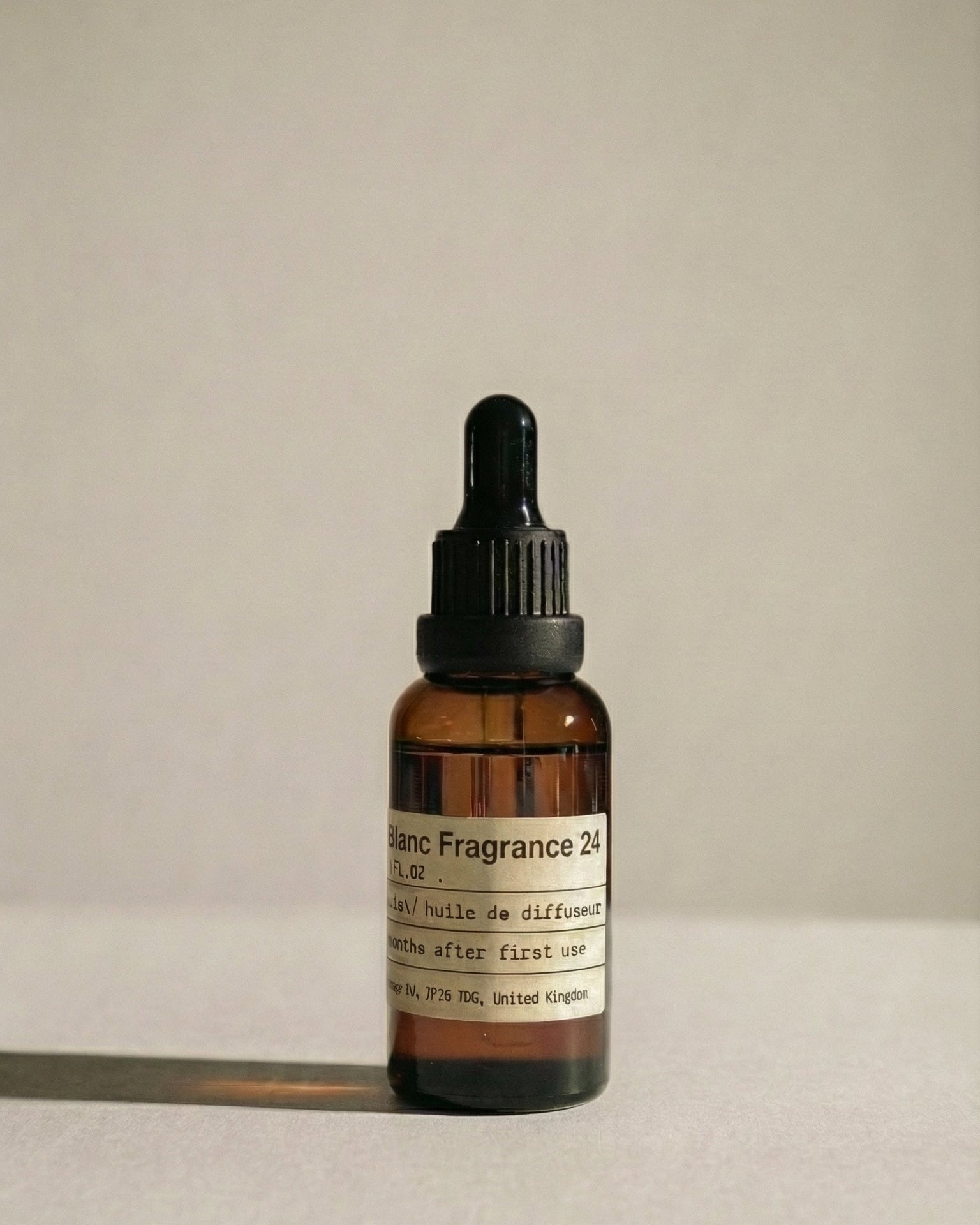 Chavanc_Aroma No. 24 Midnight Voyage essential oil in a vintage amber glass bottle, apothecary label design.