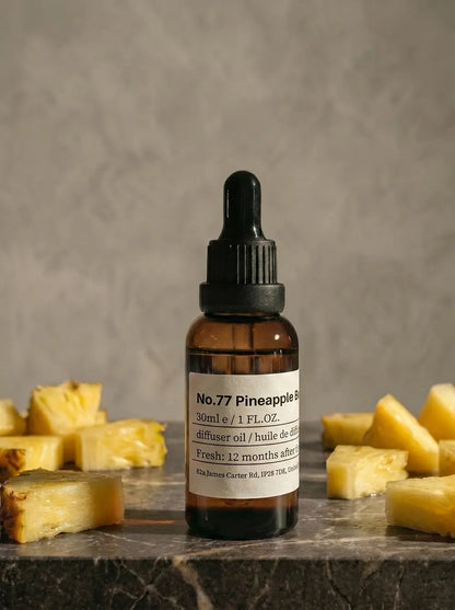 Amber glass bottle of Chavanc_Aroma  77 Pineapple Bliss Noir essential oil with vintage apothecary label.