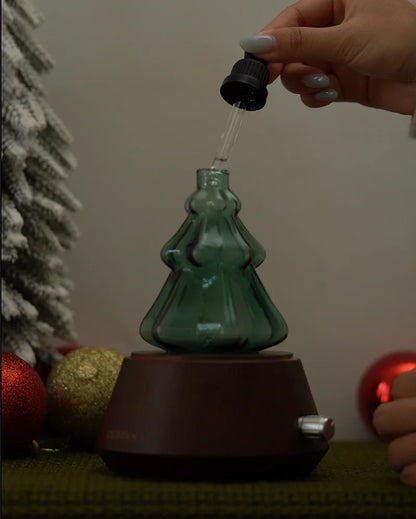 Adding pure botanical essential oil with glass dropper into Chavanc emerald green Christmas tree nebulizing diffuser flask