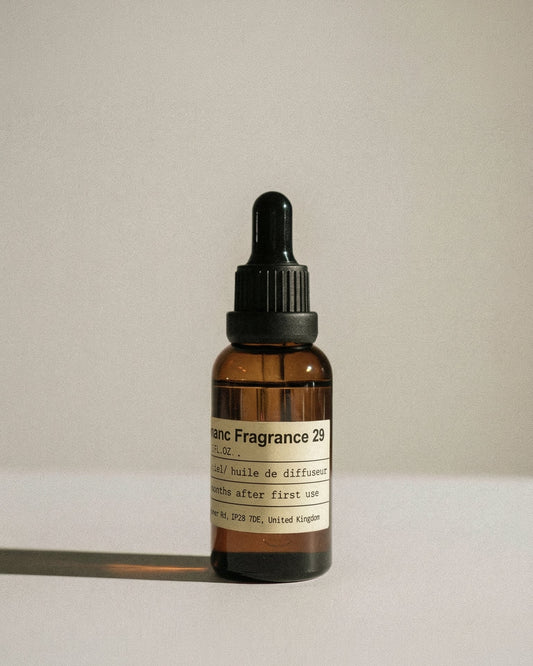 Vintage amber glass bottle of chavanc aroma 29 Santal Manuscript, featuring a minimalist apothecary label.