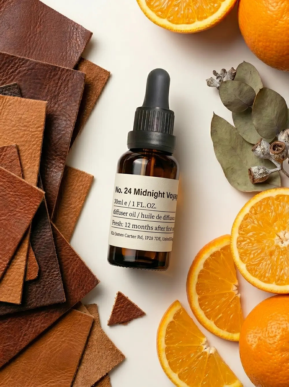 Chavanc Aroma NO.24 Midnight Voyage essential oil bottle styled with fresh oranges, lemons, dried lavender buds, and green leaves, representing a bold citrus and floral blend.