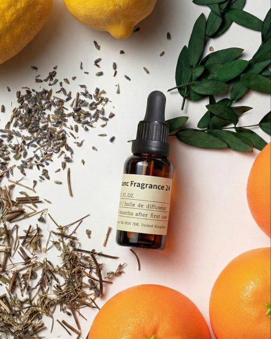Chavanc Aroma NO.24 Midnight Voyage essential oil bottle styled with fresh oranges, lemons, dried lavender buds, and green leaves, representing a bold citrus and floral blend.
