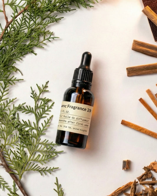 Chavnanc Fragrance NO.29 Santal essential oil bottle styled with fresh green pine branches, sandalwood sticks, and leather accents for a cozy ambiance.